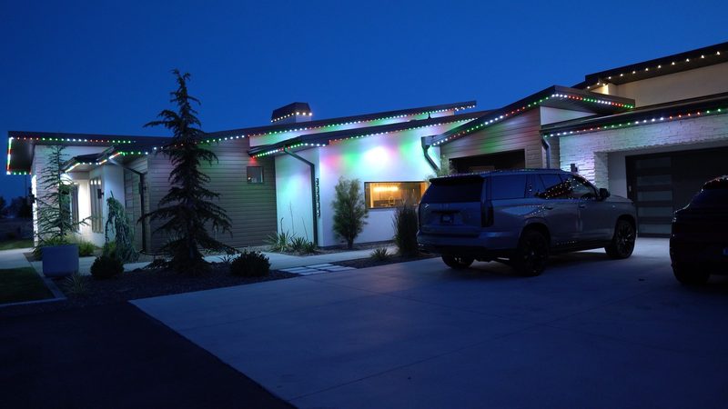 A modern stucco home in red and green