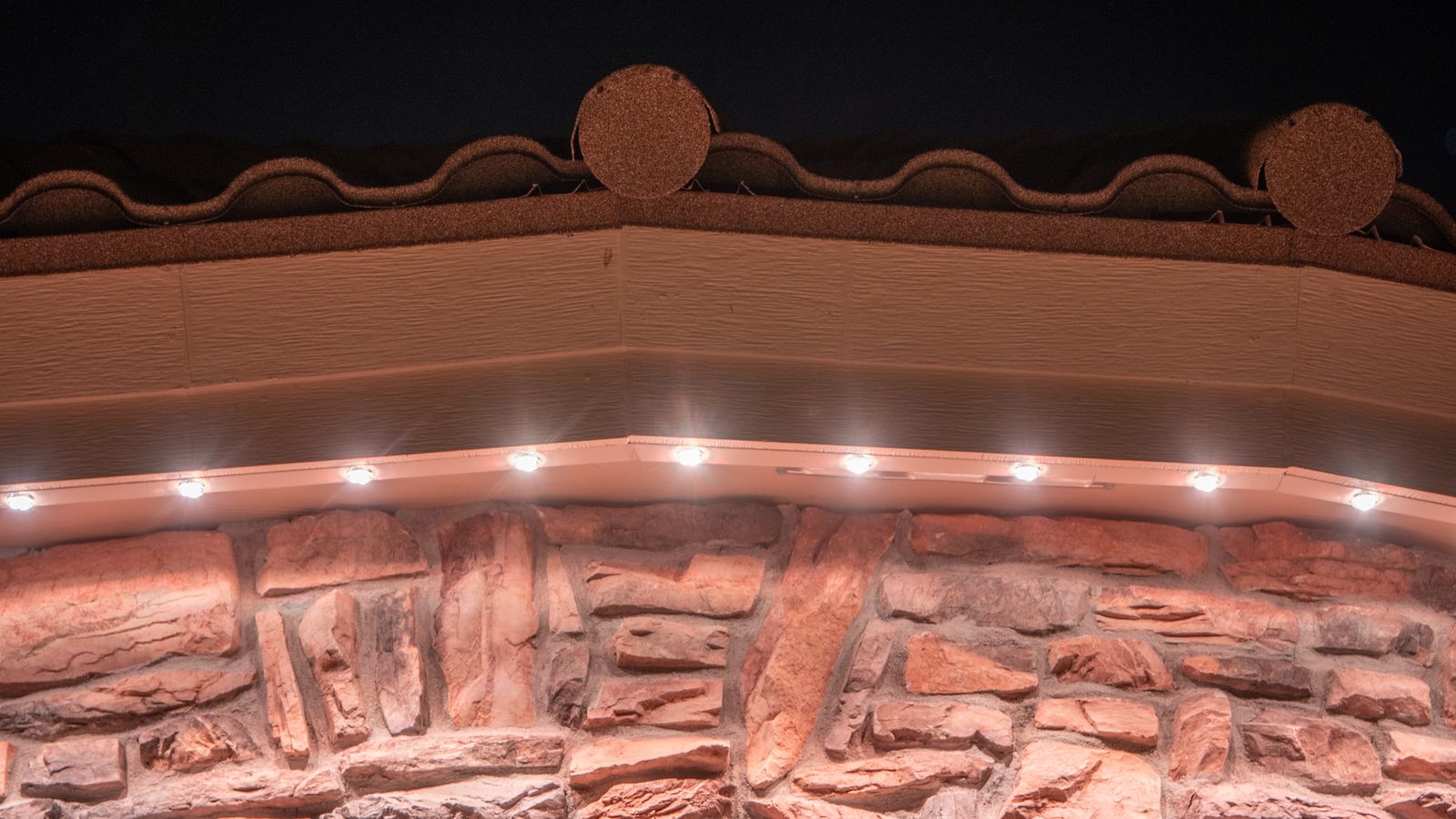 Fence-line lighting in a backyard